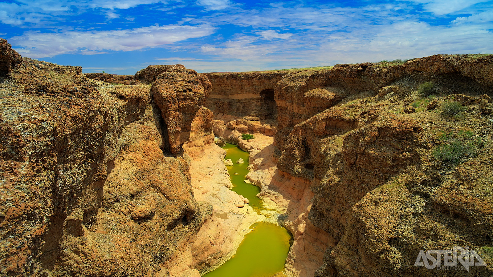 Sesriem Canyon, een 1km lange canyon, uitgeslepen in zandsteen door het water van de Tsauchabrivier